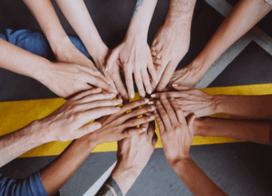 Diverse people joining hands